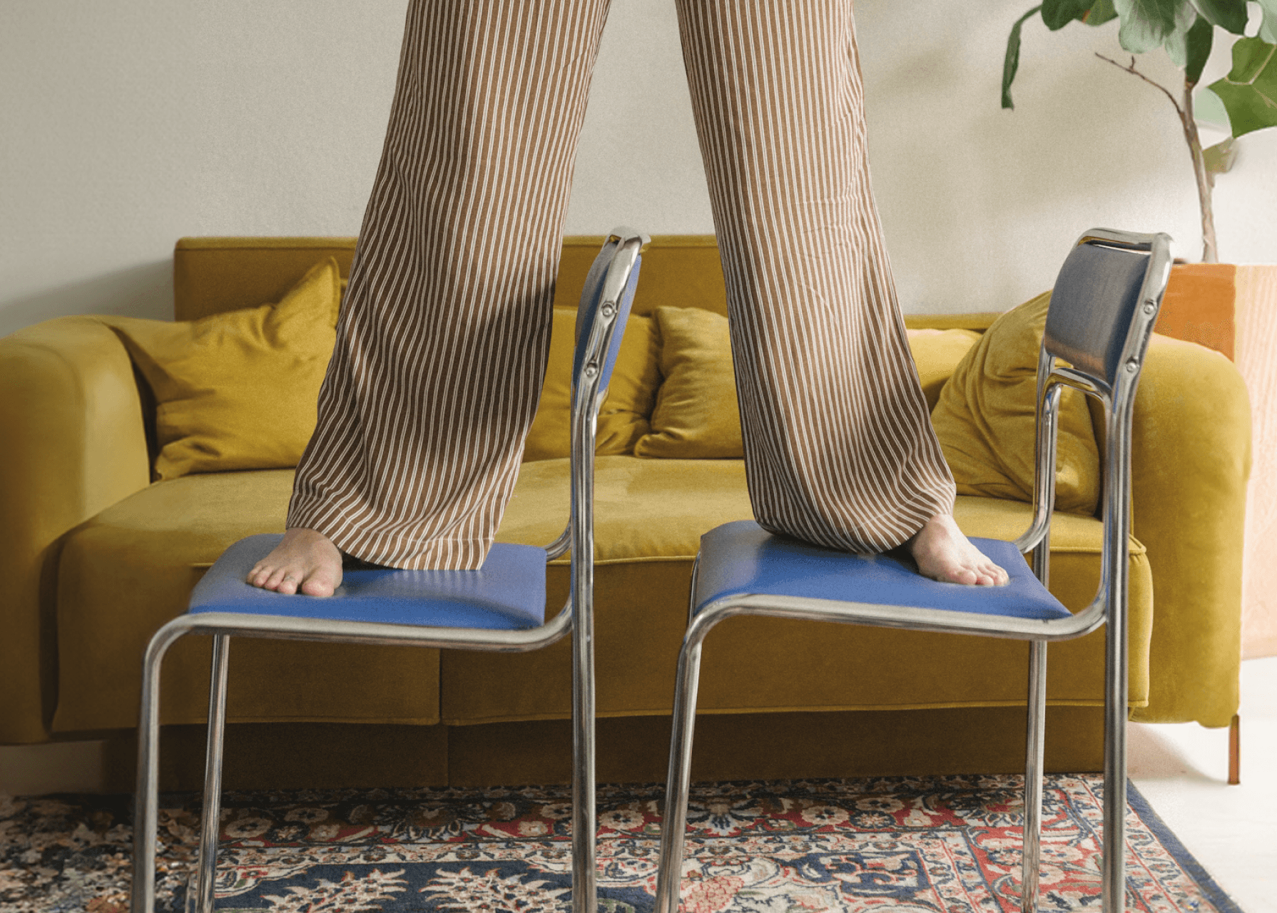 Legs standing on two chairs