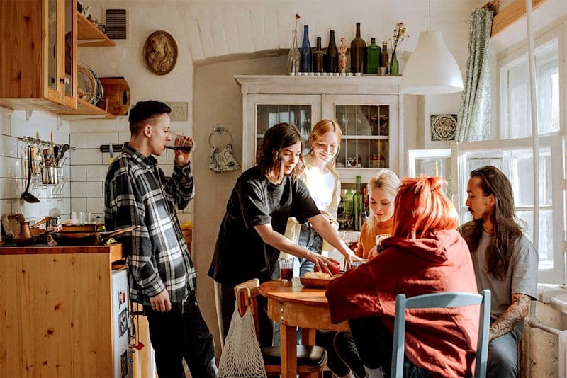 A group of friends sitting around a table laughing