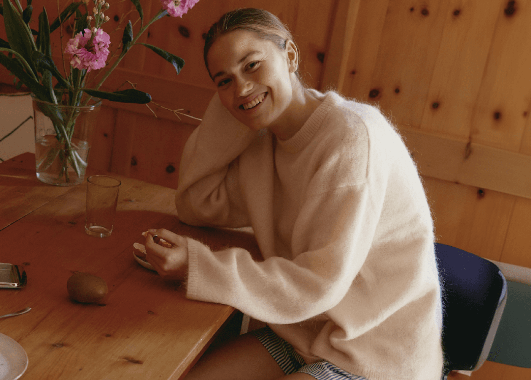 Woman sitting at a wooden table